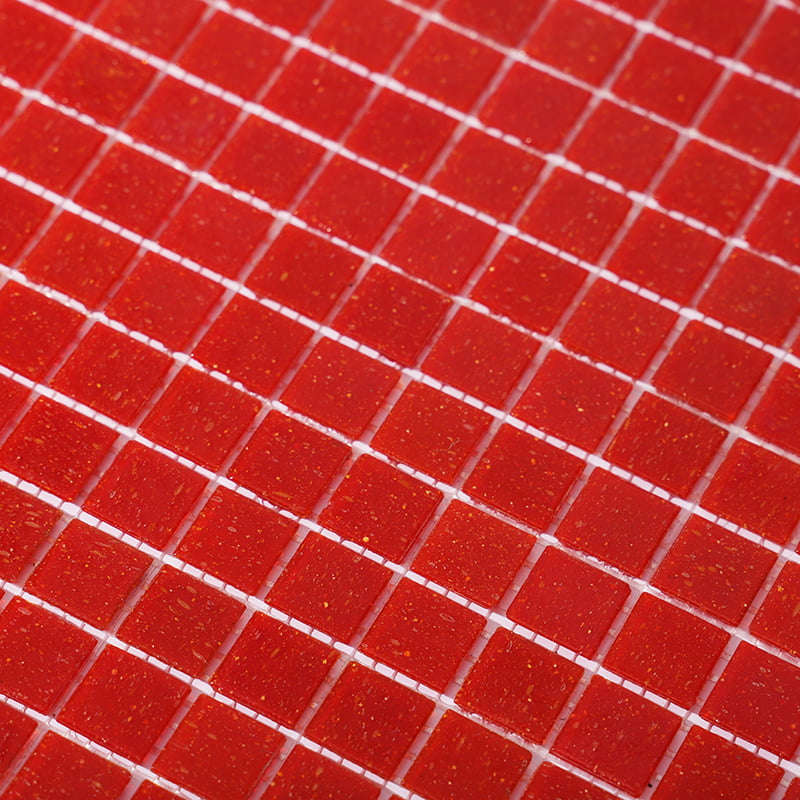 Close-up of vibrant red glass square mosaic tiles arranged in a precise grid