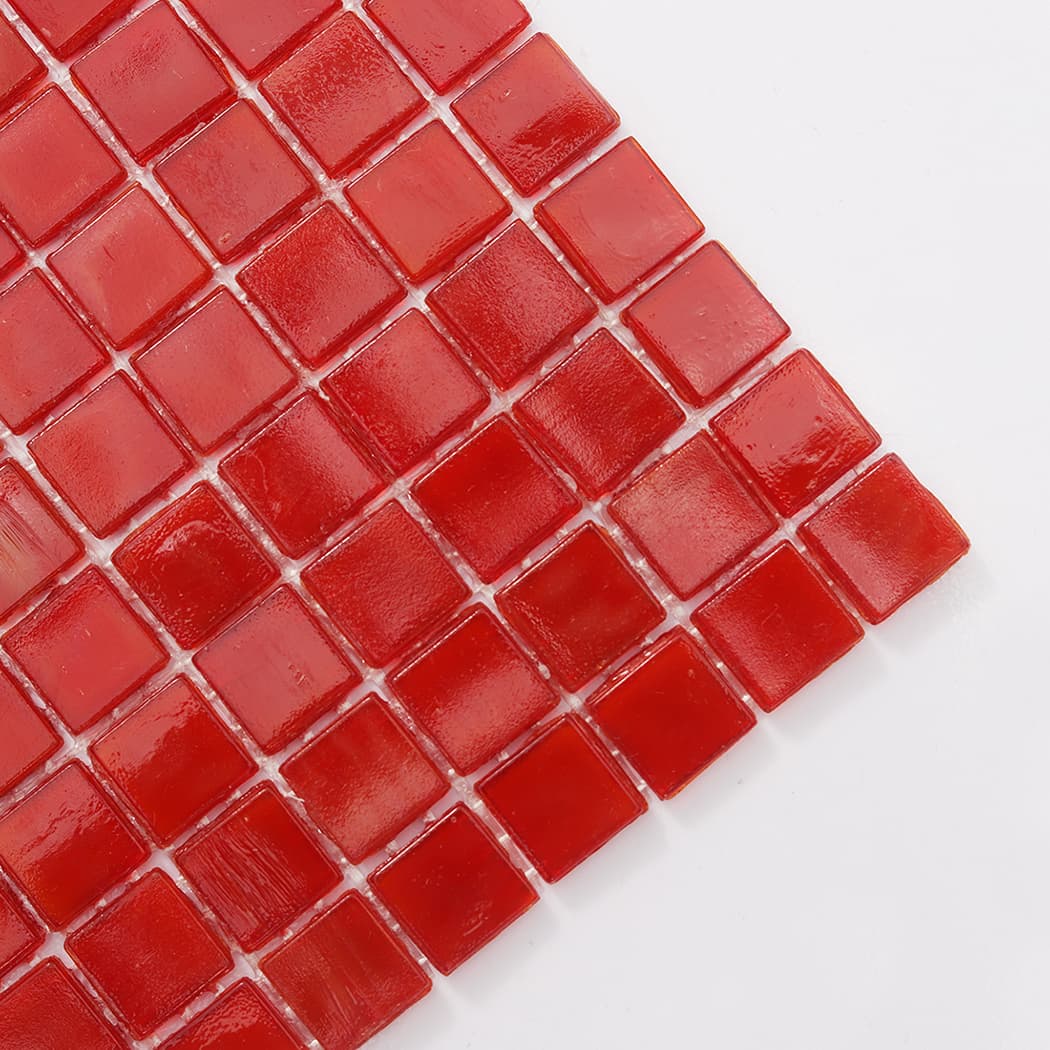 Corner close-up of red square glass mosaic tile with glossy finish