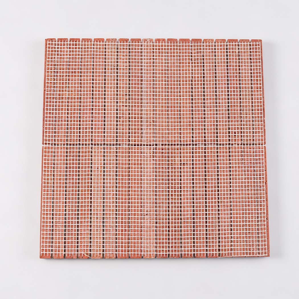 Red travertine fluted mosaic tile showing front strips and mesh backing