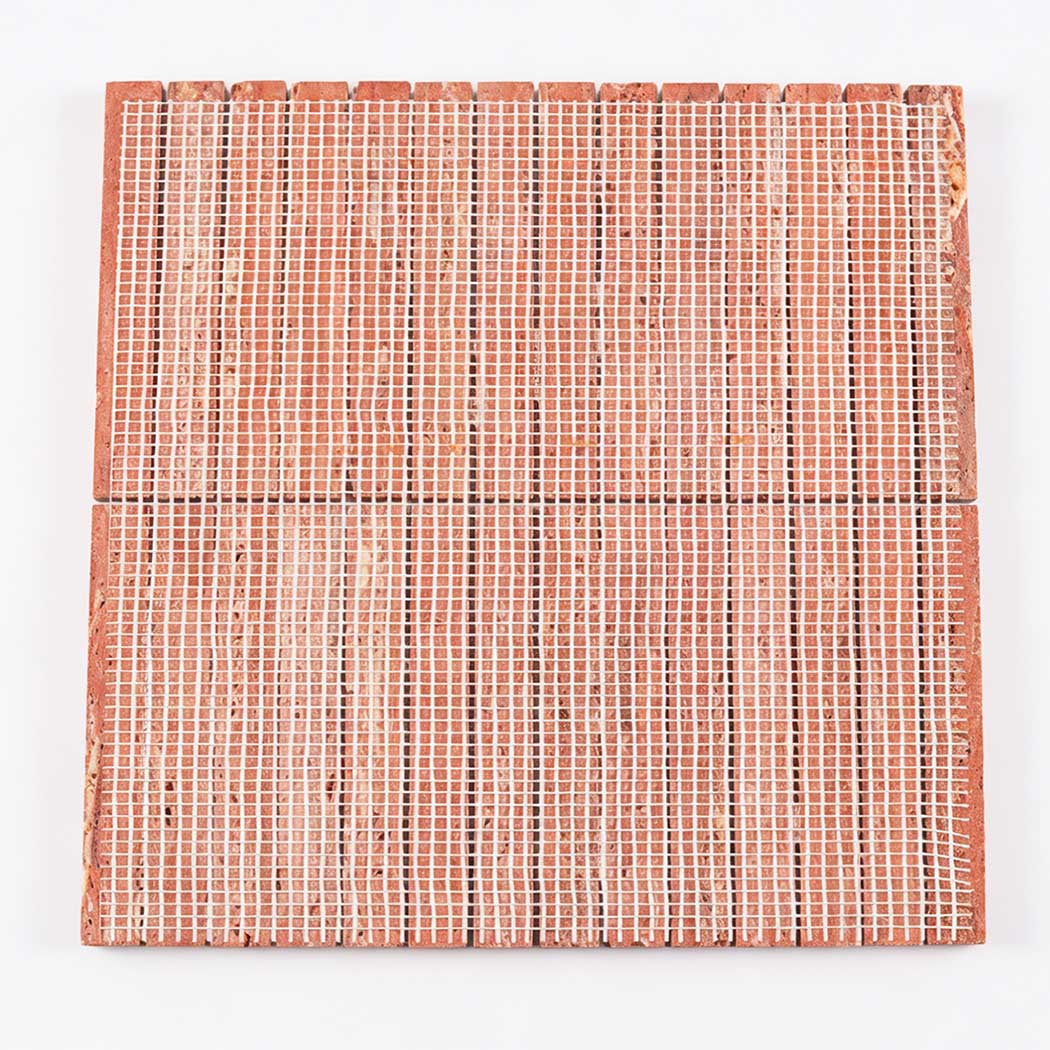 Back view of red travertine linear mosaic tile sheet with mesh backing