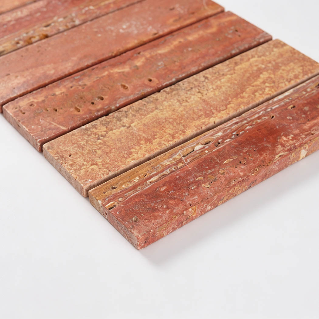 Angled close-up showing the textured surface and thickness of red travertine strips