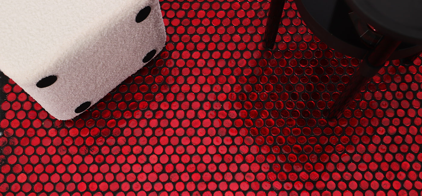 Close-up of iridescent red waterglass penny tile mosaic pattern