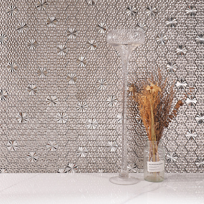 Silver geometric mosaic backsplash tiles with a tall glass vase and dried flowers