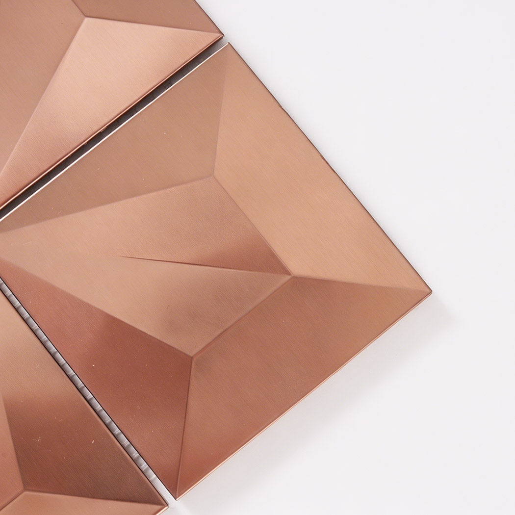 Close up of rose gold 3D pyramid square metal tile with brushed finish