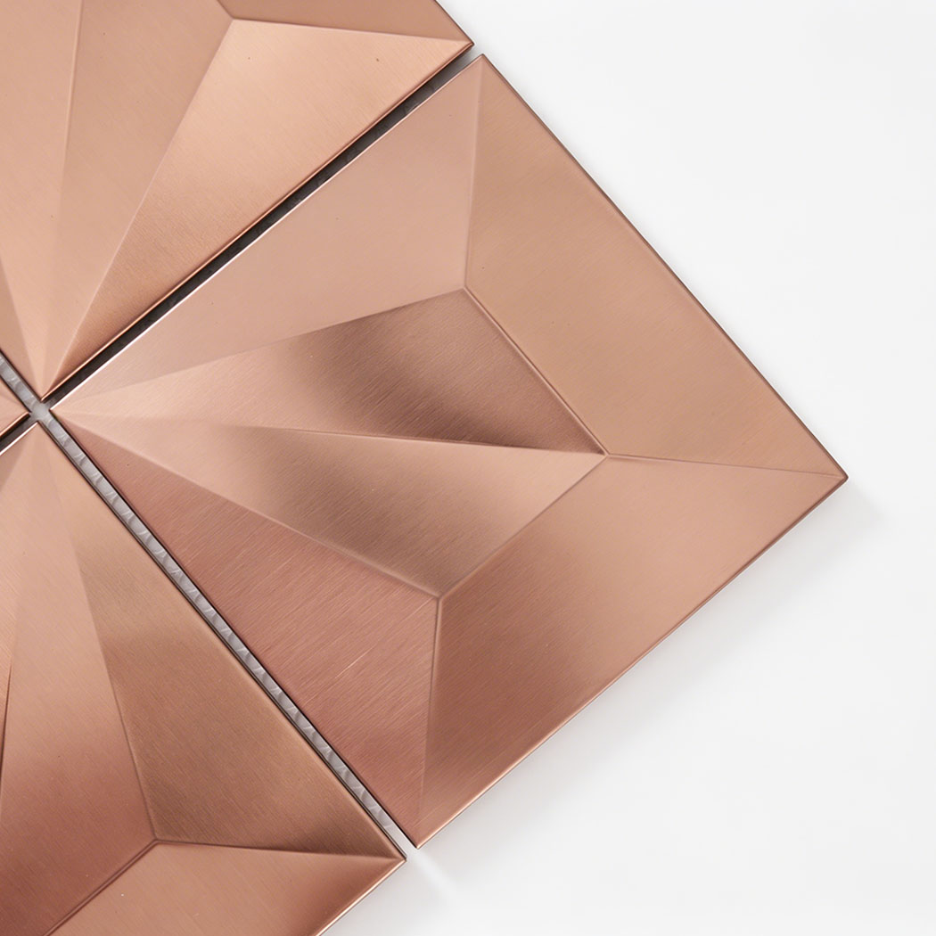 Close up of rose gold brushed pyramid square metal tile with raised facets