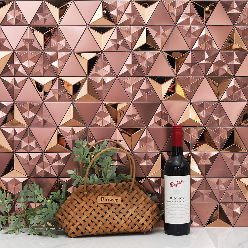 Rose gold geometric wall tiles styled with a wine bottle and a flower basket.