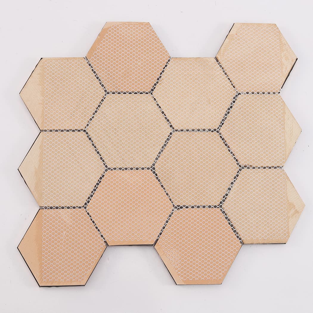 Back view of rose gold hexagon metal mosaic tile sheet with mesh backing