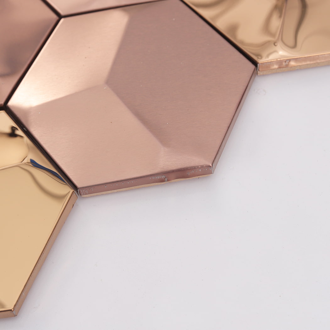 Side detail of rose gold hexagon metal tile showing raised edge thickness