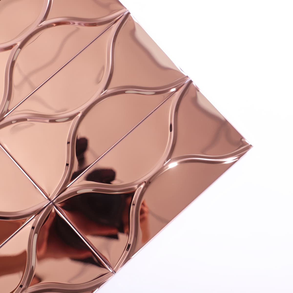 Corner angle of rose gold mirror tile showing raised 3D texture