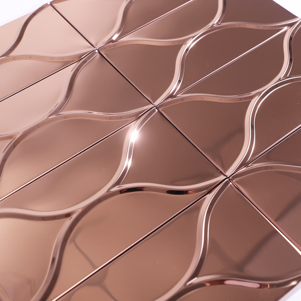 Detail angle of rose gold mirror tile with curvy 3D surface