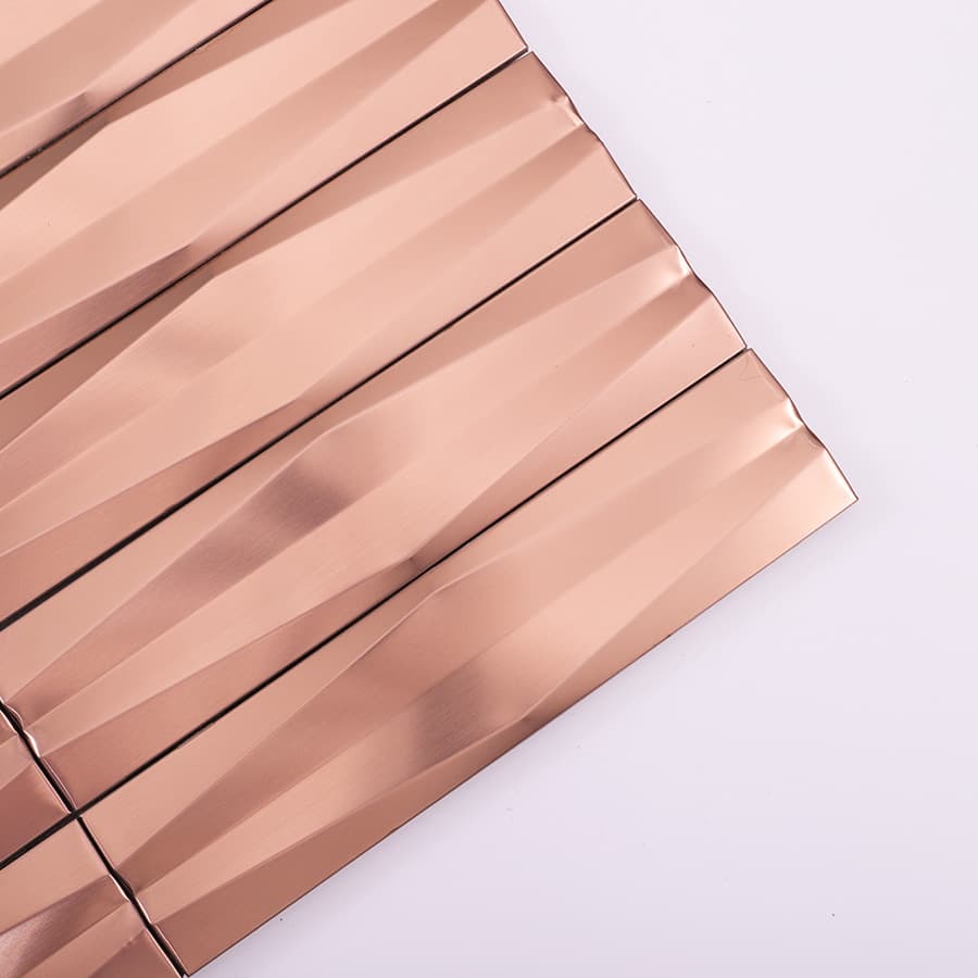 Close up view of rose gold stainless steel 3D wave strip mosaic tile