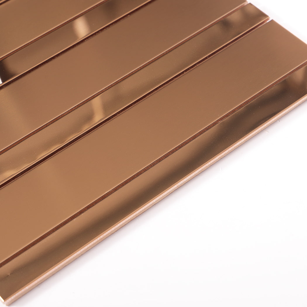Edge view of rose gold stainless steel vertical strip wall tile showing thickness
