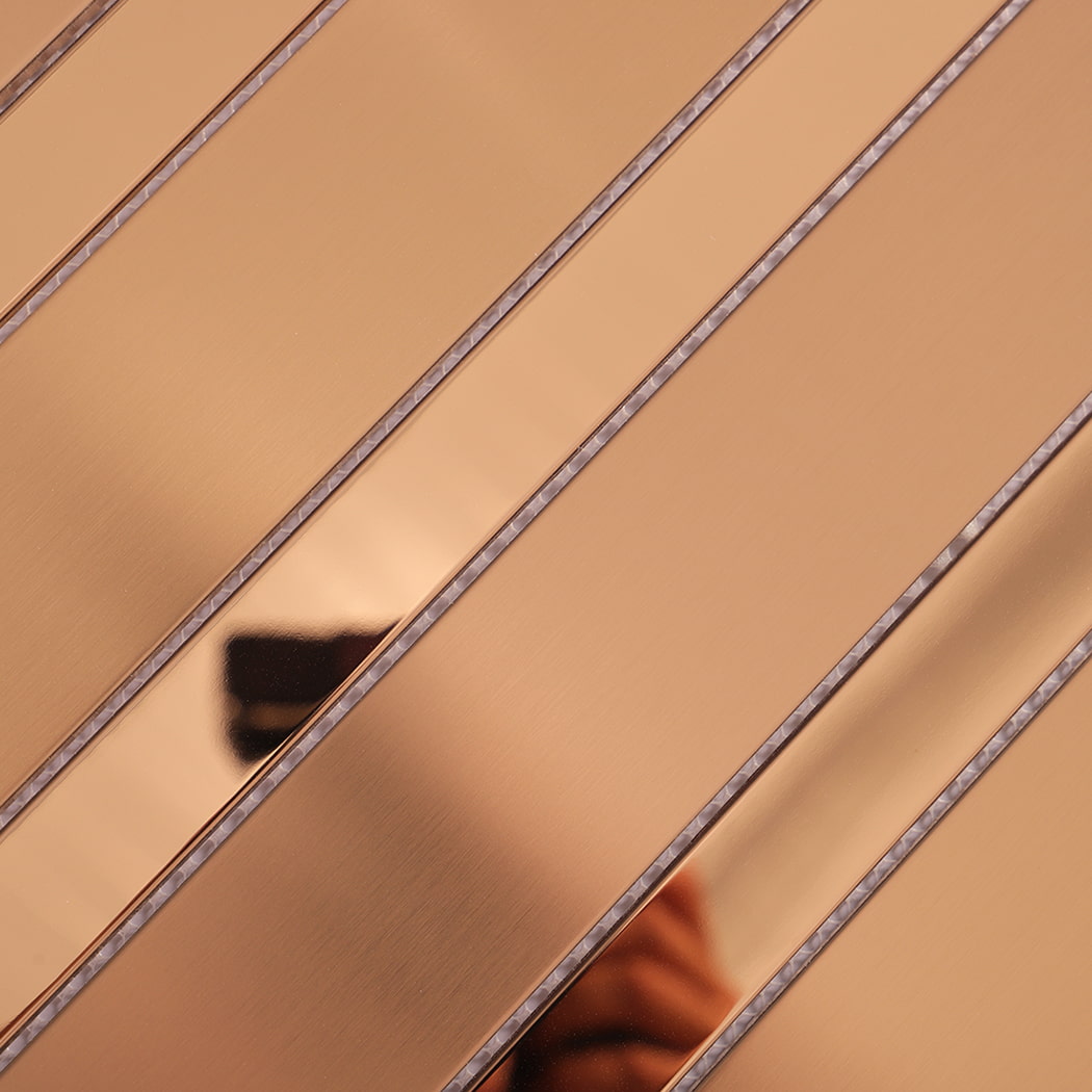 Textured surface detail of rose gold stainless steel vertical strip wall tile