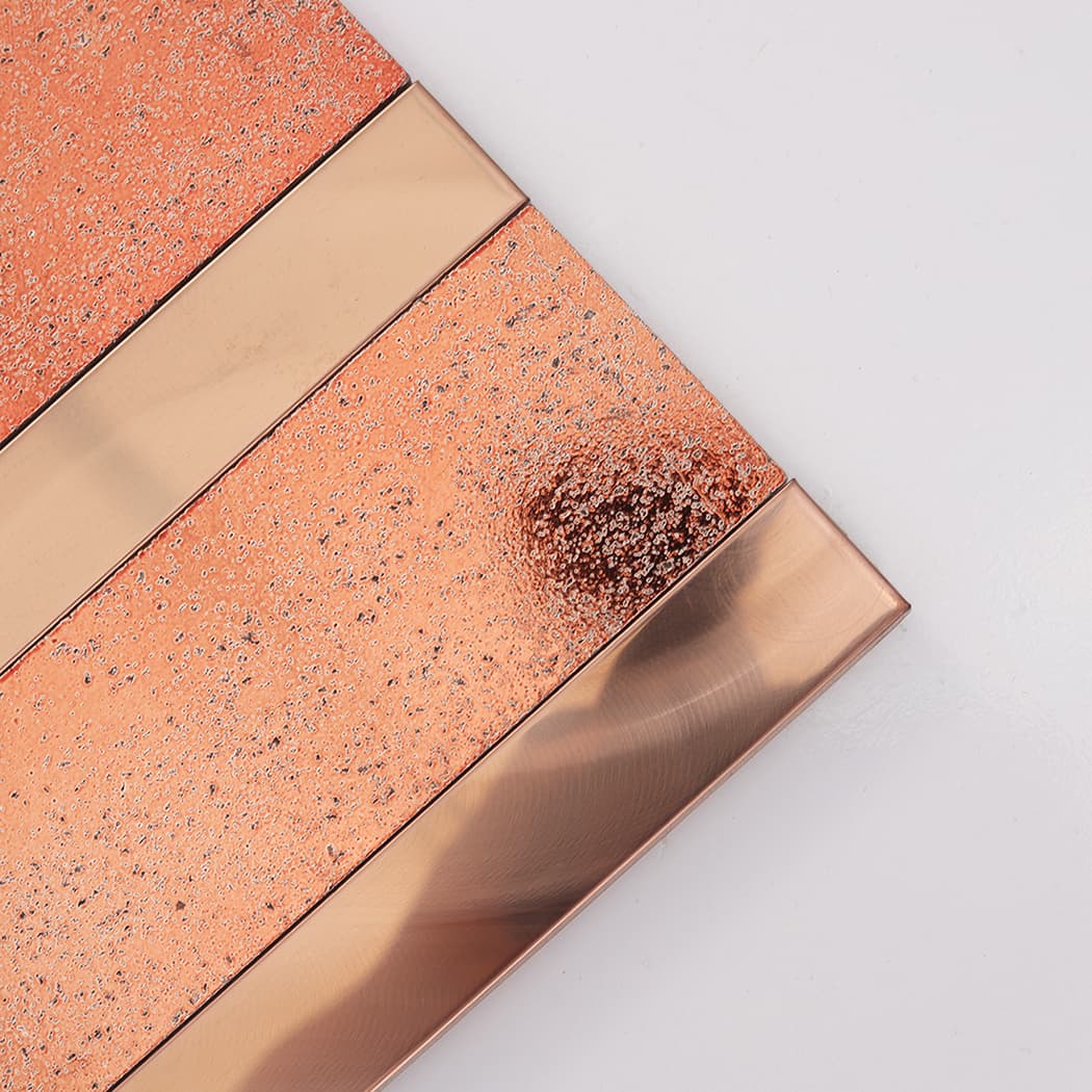 Close-up of rose gold electroplated stone with patterned metal strip detail