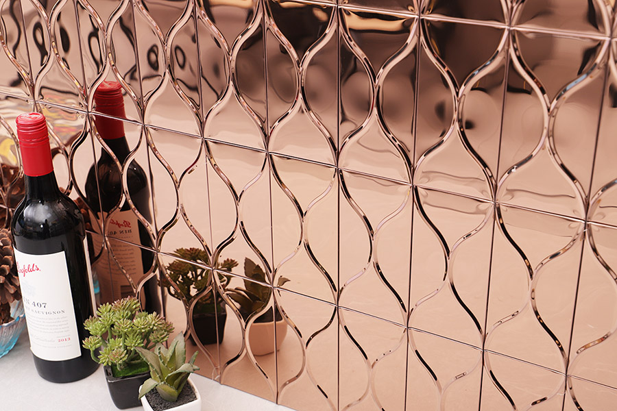 Rose gold wavy 3D glass tile wall panel with reflective metallic finish.
