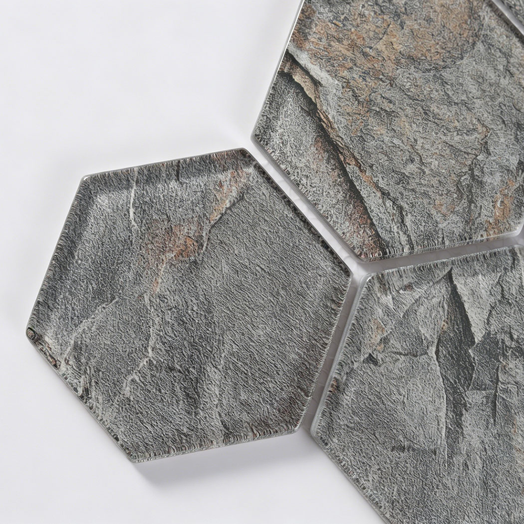 Close detail of gray slate look hexagon glass tile with beveled clear edges
