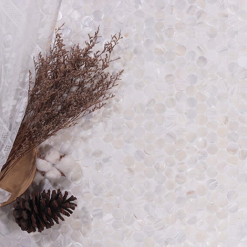 Close-up of white pearl penny tiles with dried plant decor