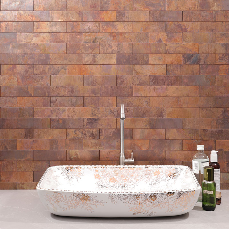 Rustic copper subway tiles behind a white bathroom sink