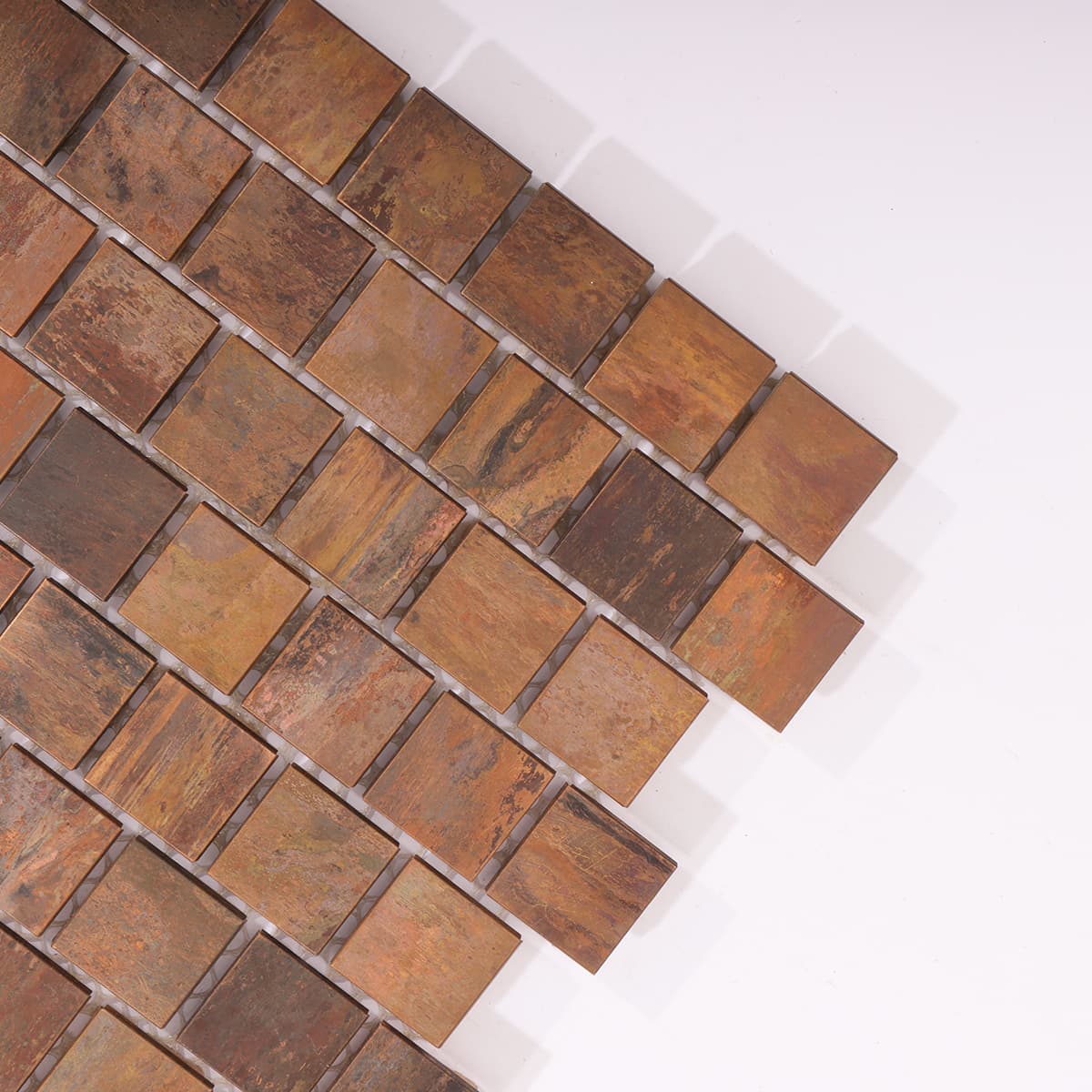 Corner detail of square copper tiles with rustic matte finish