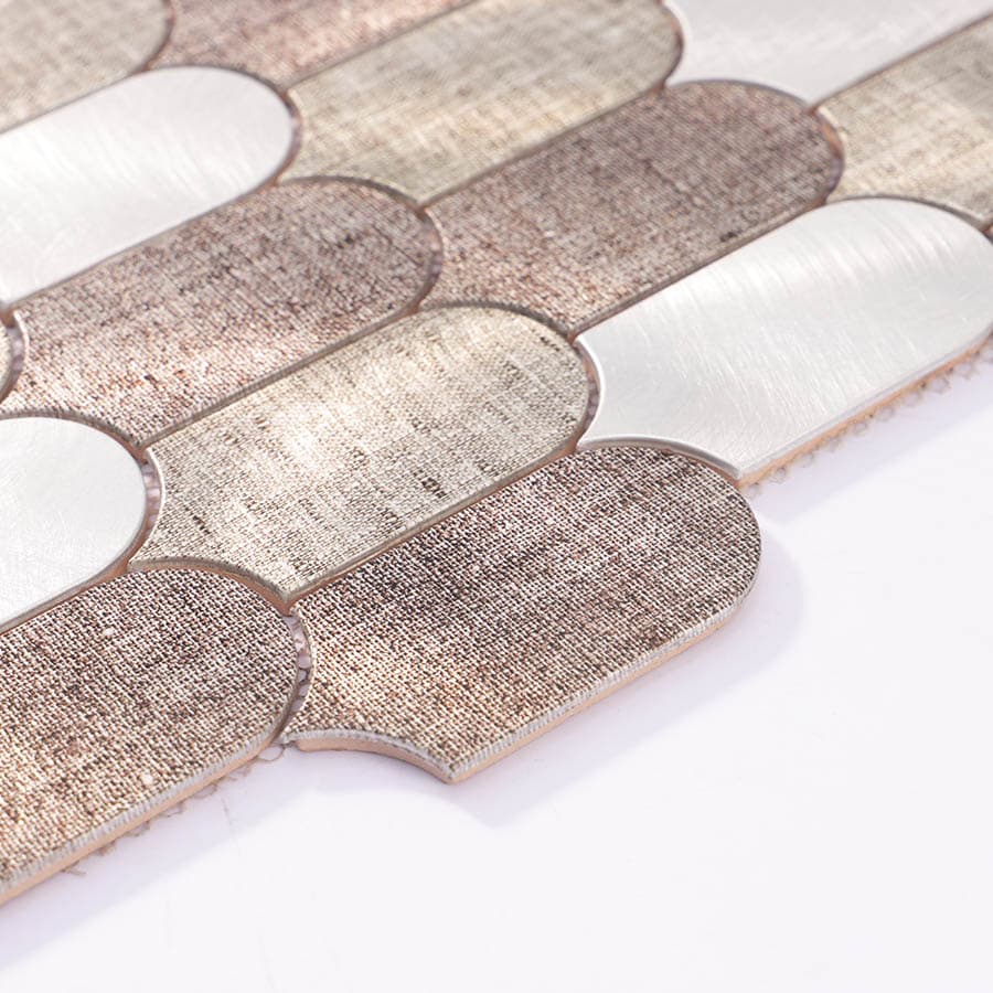 Angled perspective of brushed aluminum scallop tile showing depth and reflection