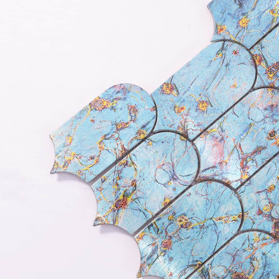 Close-up of corner showing blue marble-effect scallop tile with metallic luster