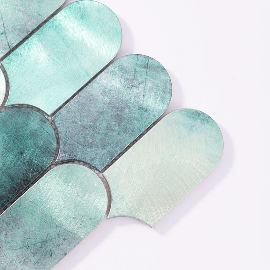 Close-up of brushed green aluminum scallop tile corner pieces