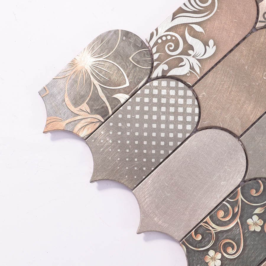  Close-up of tile corner showing brushed rose gold surface and floral patterns