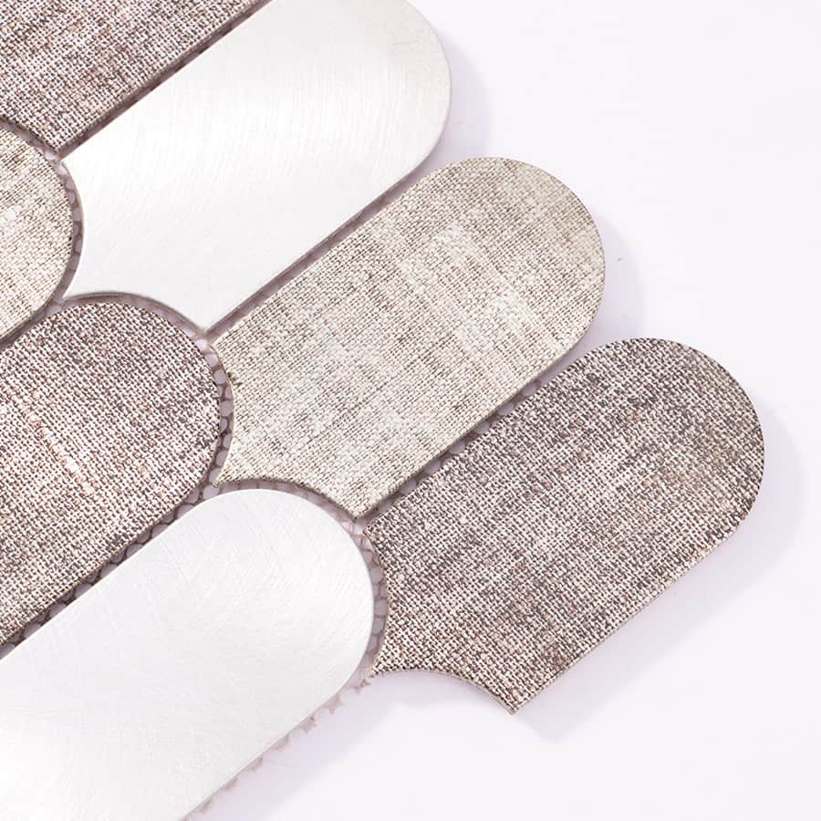 Close-up of the corner section showing brushed and fabric-textured aluminum pieces