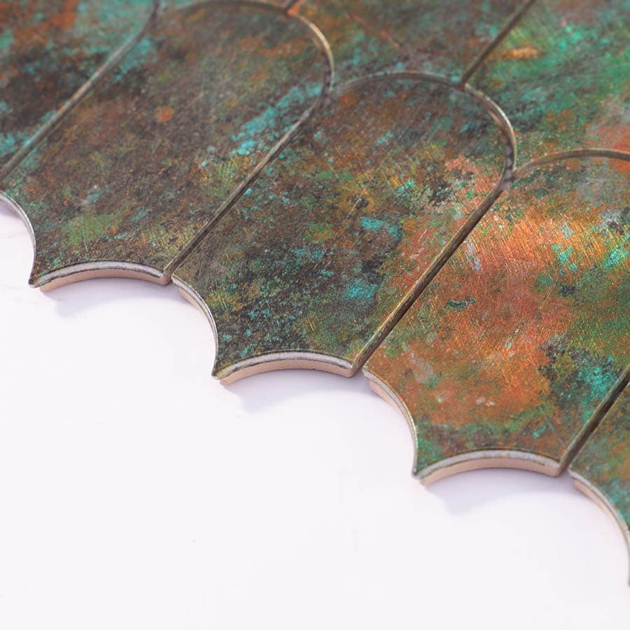 Angled side view of scallop tile highlighting patina blend and metal layering