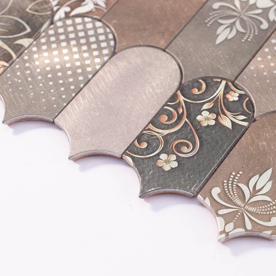 Side angle view of decorative scallop tile with floral and dot textures