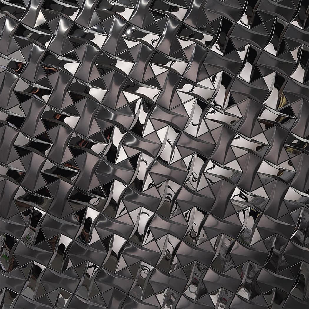 Close up of high gloss 3D tiles reflecting light on a textured feature wall.