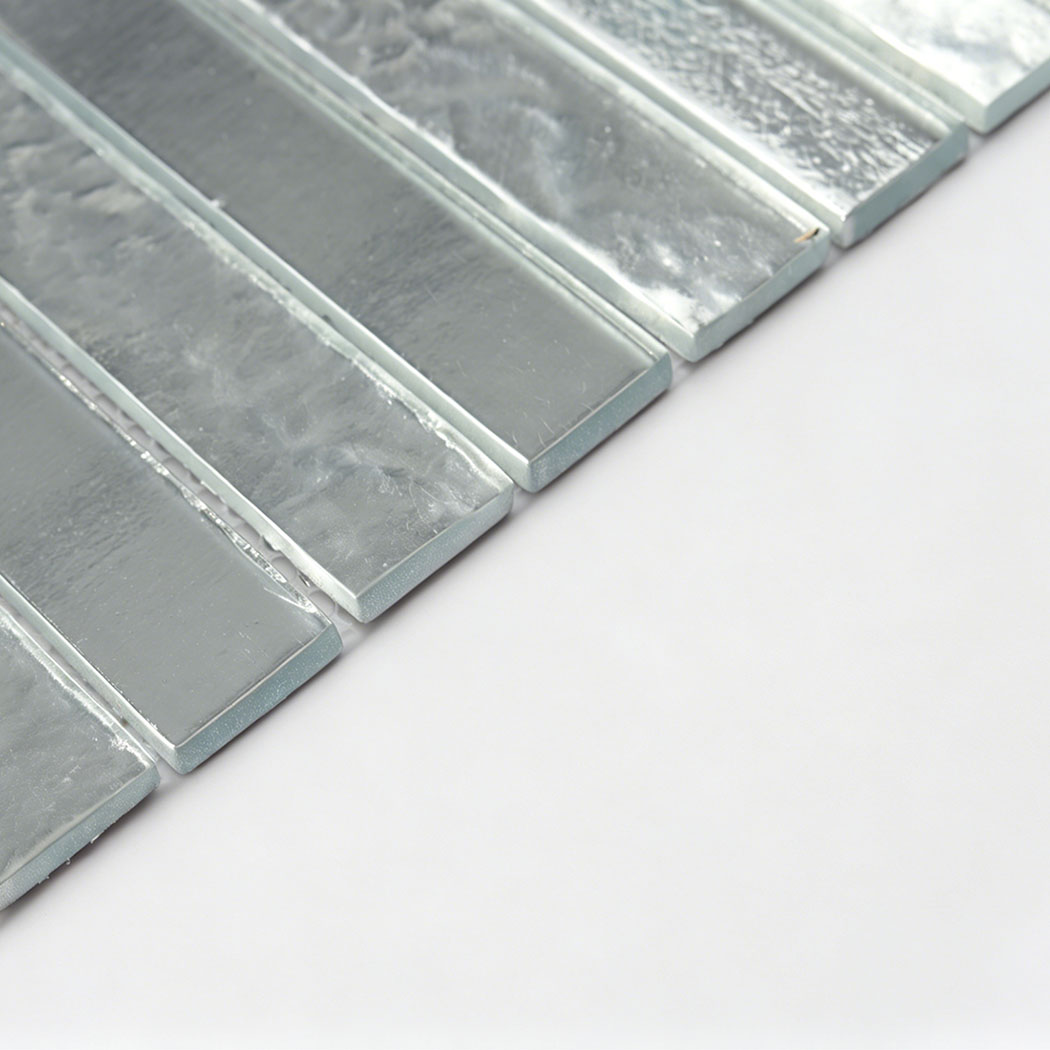 Angled side profile view showing the thickness of the silver linear glass tile.