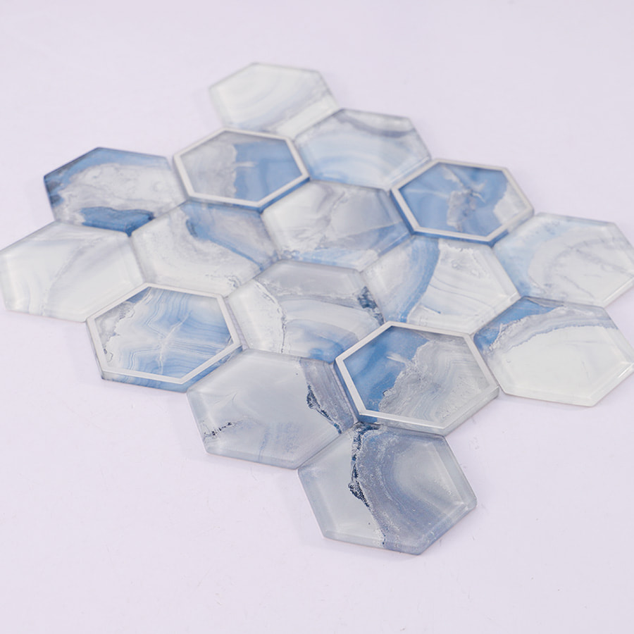 Side view of blue and white hexagon glass mosaic tile sheet on white background