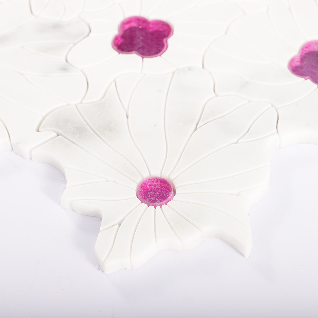 Side view of white marble flower mosaic tile with pink glass accents.