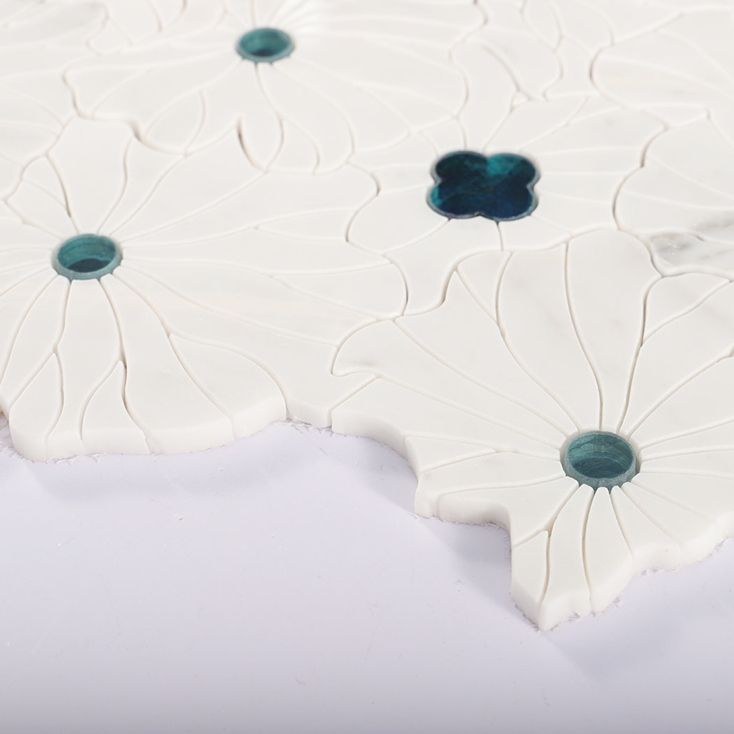 Side view of flower-shaped marble mosaic tile with blue glass accents.