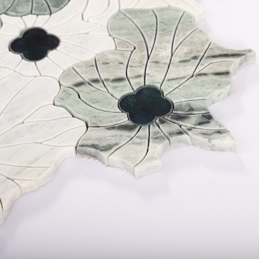 Side view of green and white flower marble mosaic tile with dark blue glass centers.