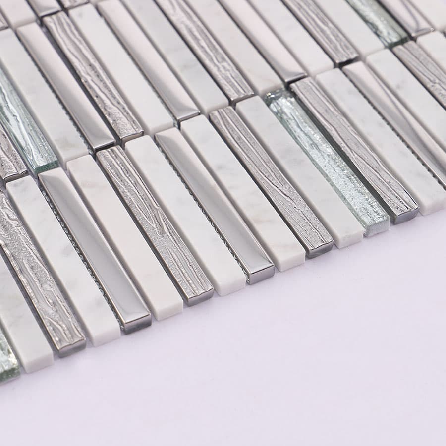 Side view of silver glass and white marble mosaic tile sheet edges