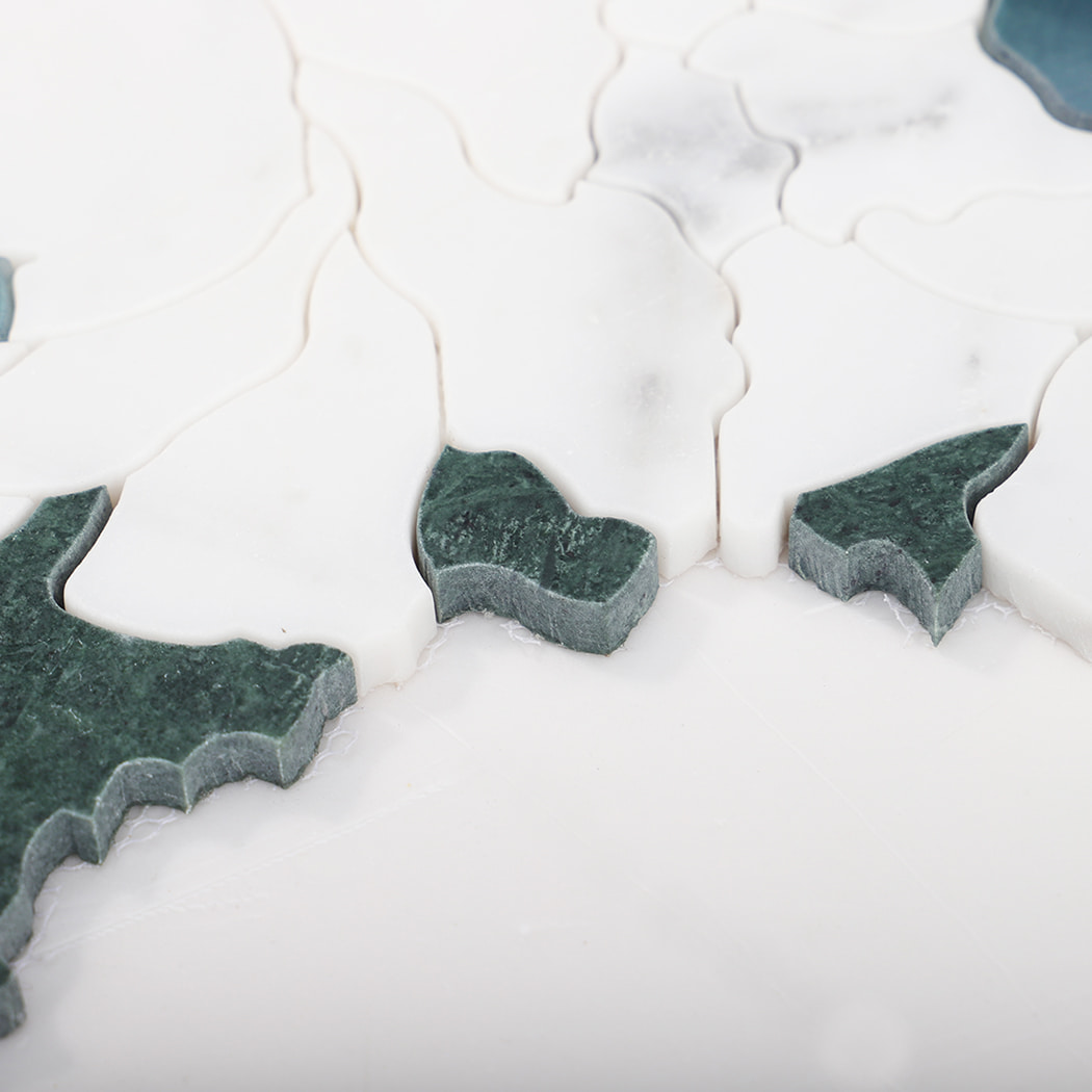 Side view showing white marble flower mosaic tile with green stone accents.