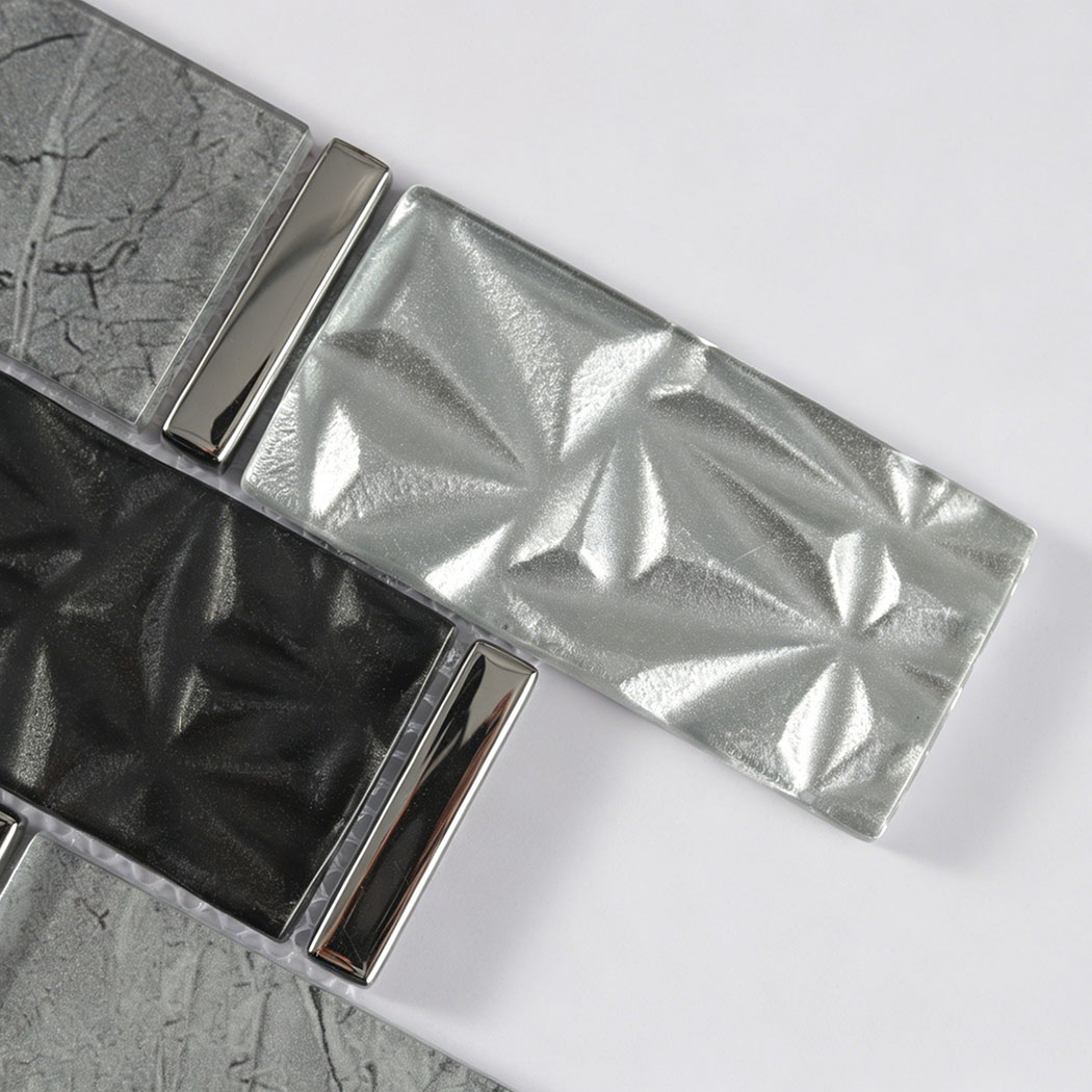 Close up of silver 3D glass, black glass and chrome metal subway mosaic