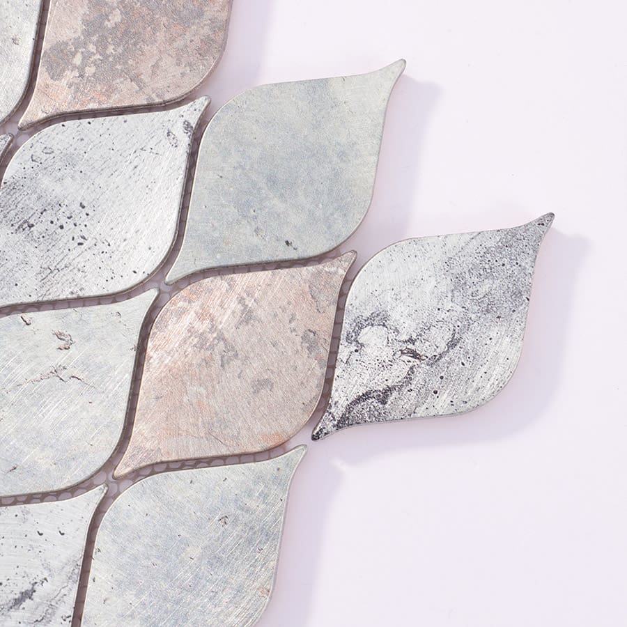 Corner close-up of silver and bronze leaf mosaic tile