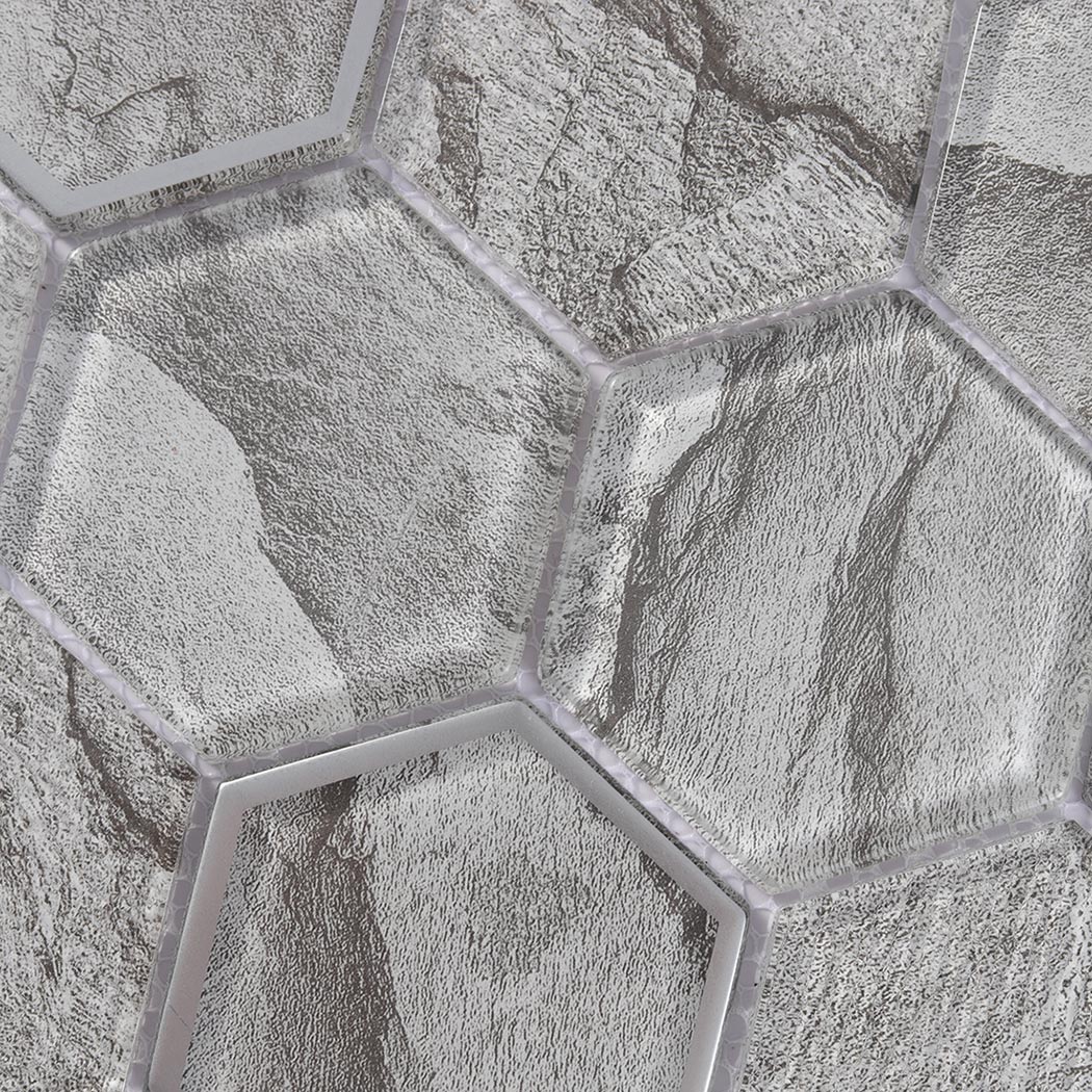 Macro view of gray slate look hexagon glass tiles with silver glass framed accent