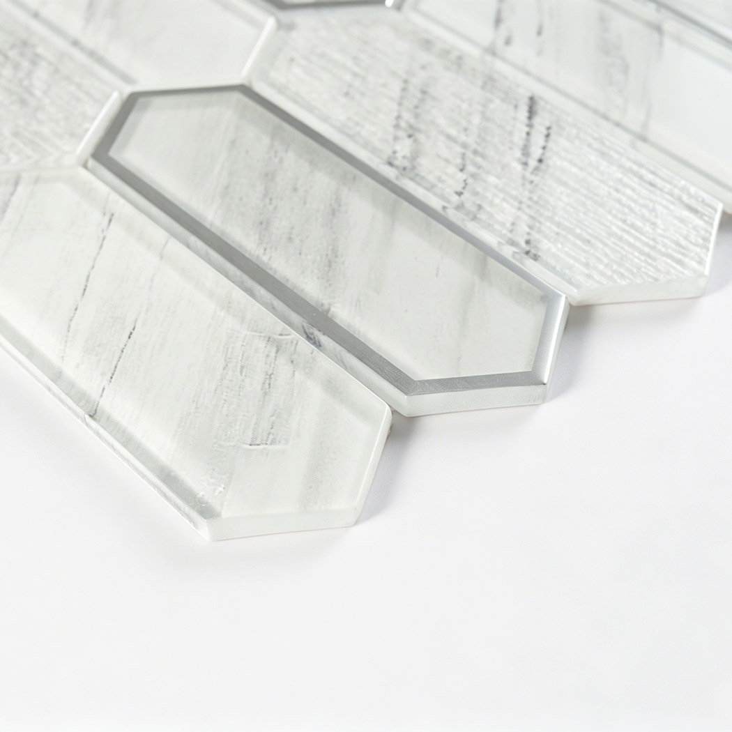 Angled white marble picket glass tile detail with silver framed accent piece