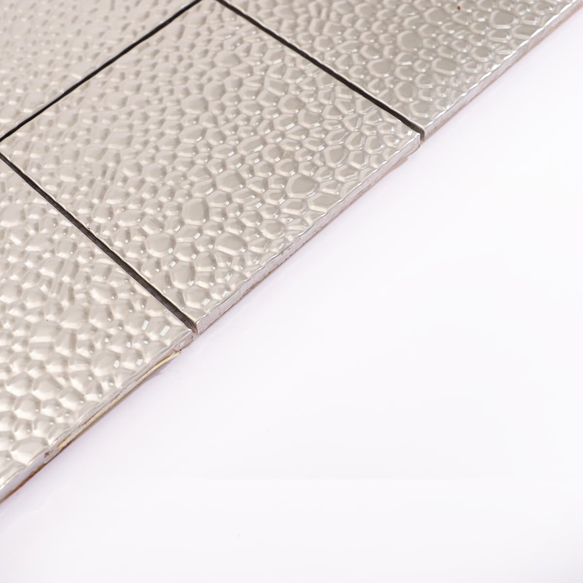 Edge view of silver hammered mosaic tile sheet