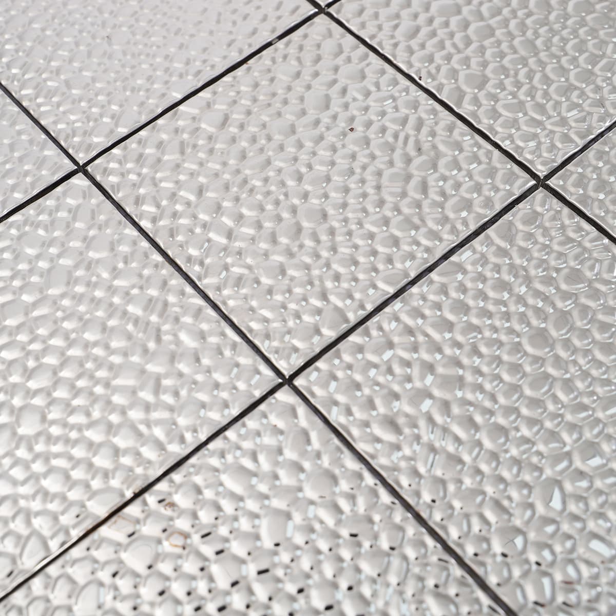 Texture detail of silver hammered stainless mosaic tile