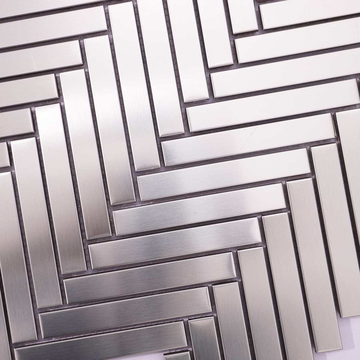Brushed silver herringbone mosaic close-up pattern