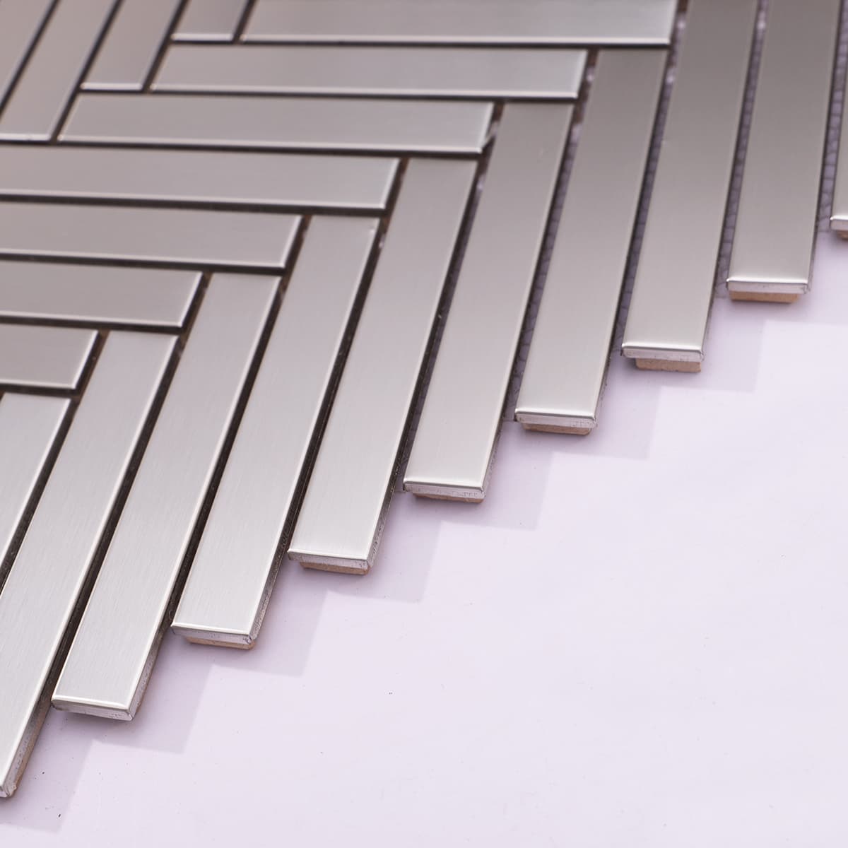 Side view showing thickness of stainless steel herringbone tile