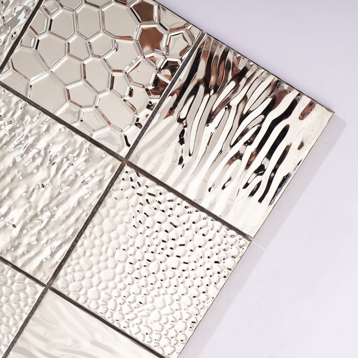 Close-up of silver mixed texture mosaic tile from the corner