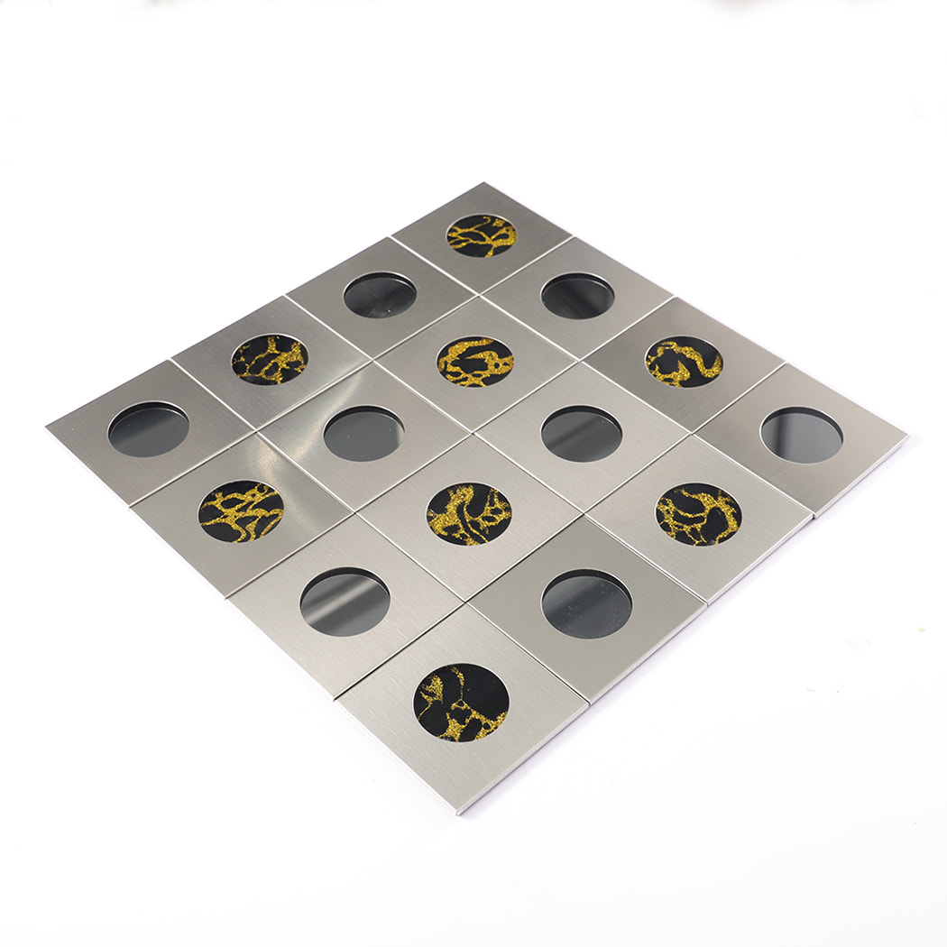 Angled view of silver mosaic tile showing circular mirror and golden design.