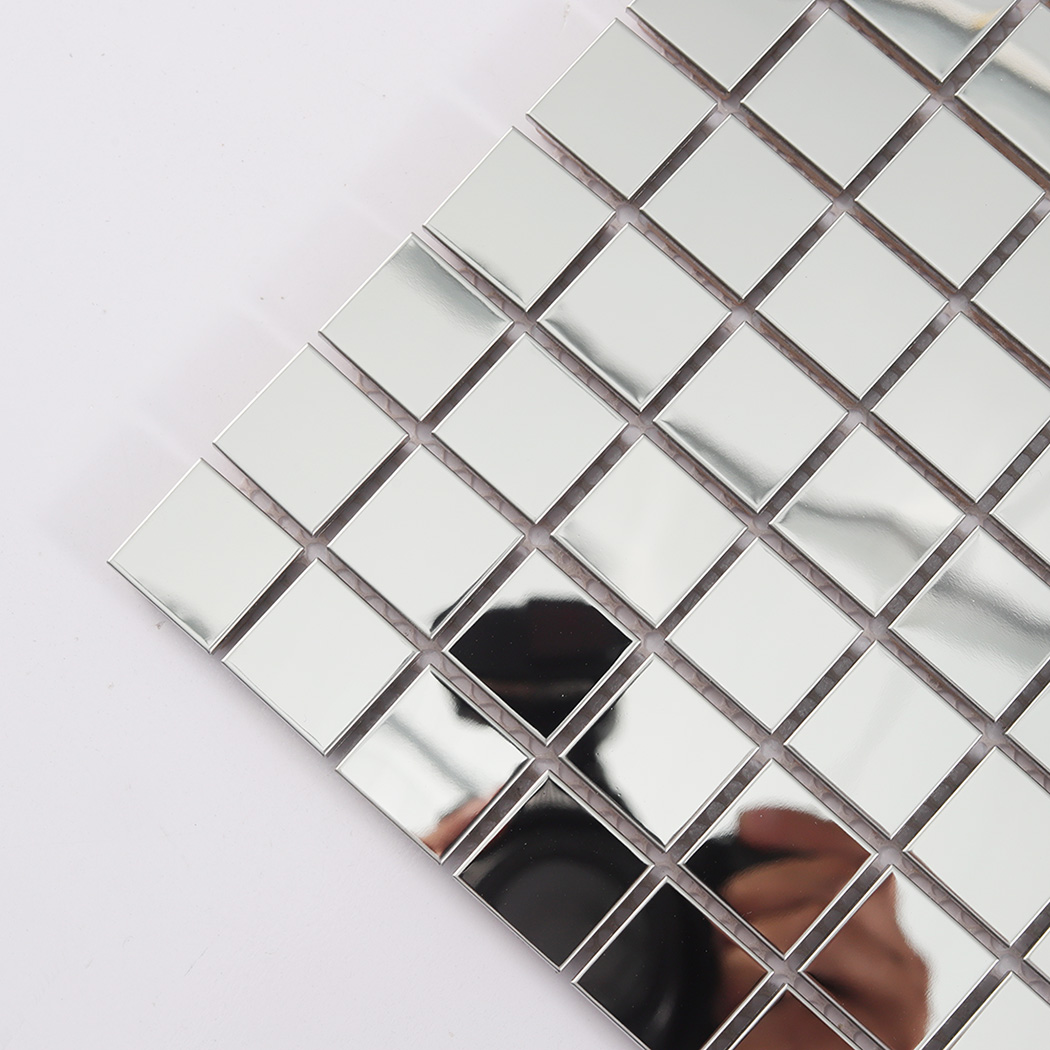 Corner close-up of silver square mirror metal tiles with reflective surface