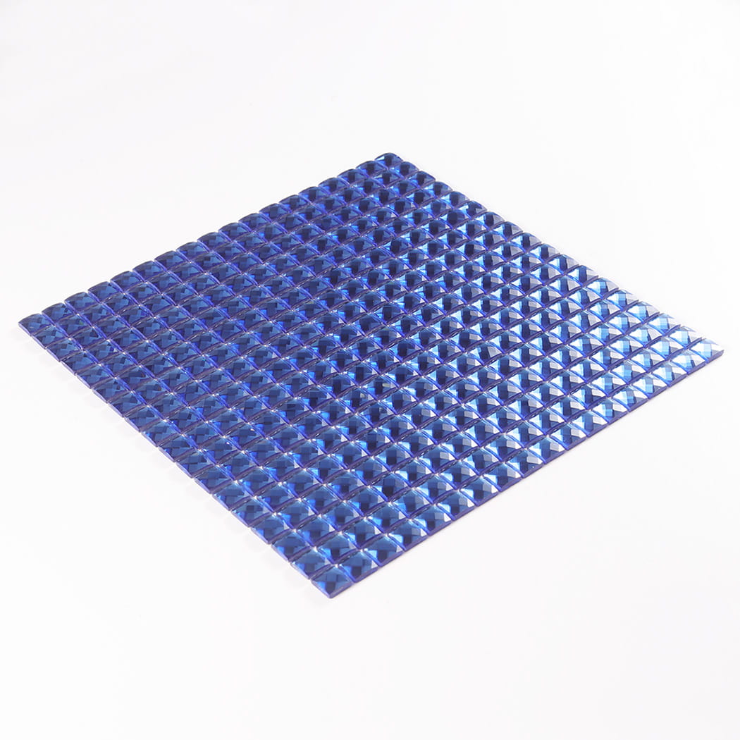 Slanted isometric view of a complete sheet of blue mirror glass mosaic tiles.